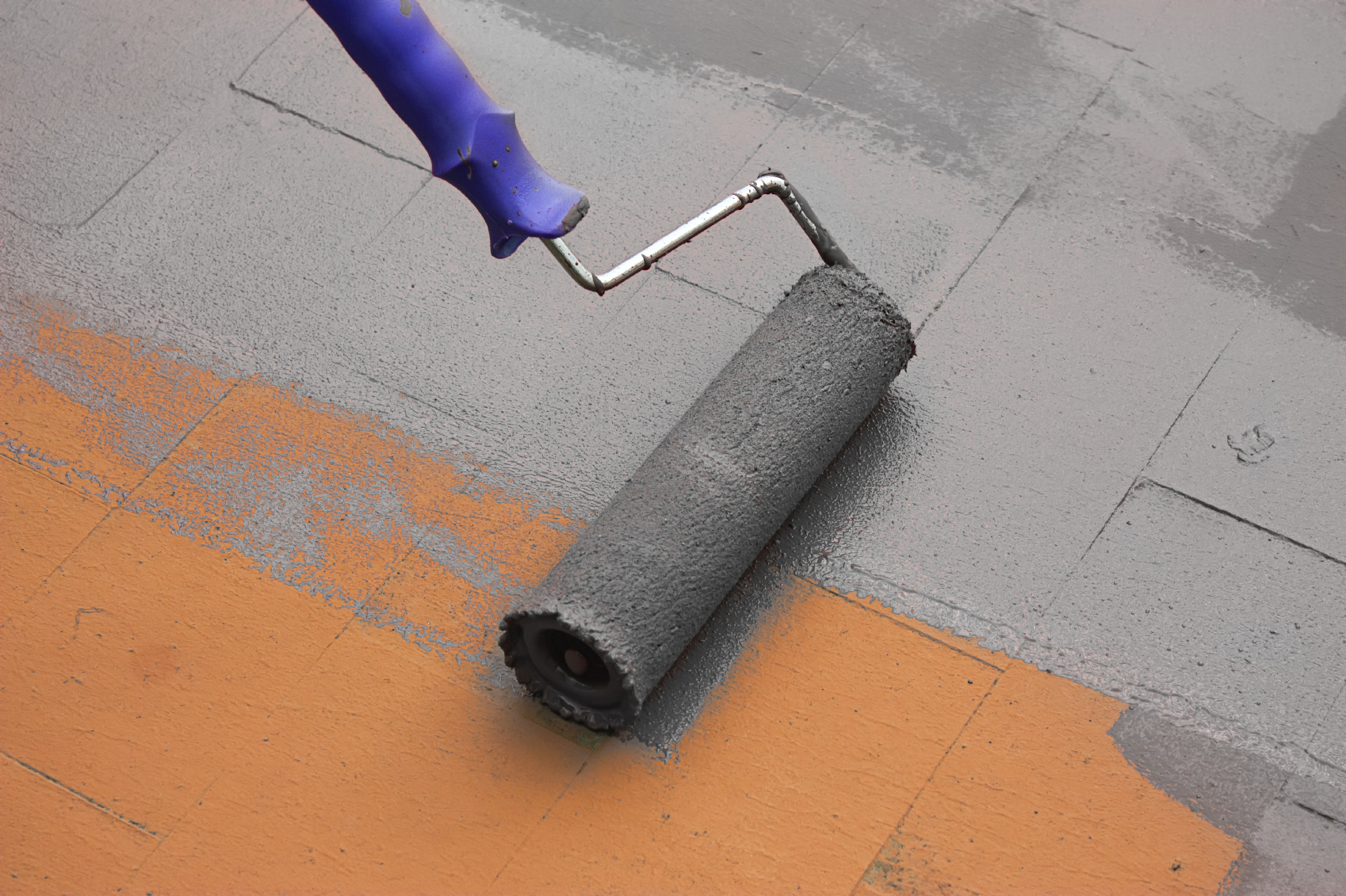 Contract painter painting a floor with a paint roller Colormaker