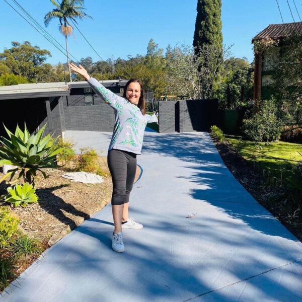 Libby Lombardo - photo of Libby on driveway which has been resurfaced with ACRYLMERIC Concrete Sealer in Light Grey